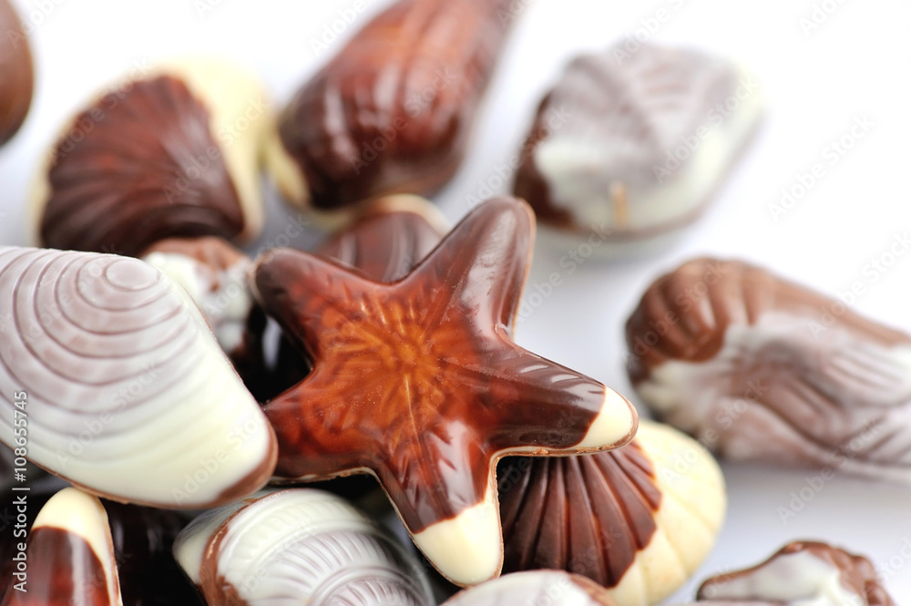 Swiss chocolate seashells on white background Swiss chocolate seashells on white background