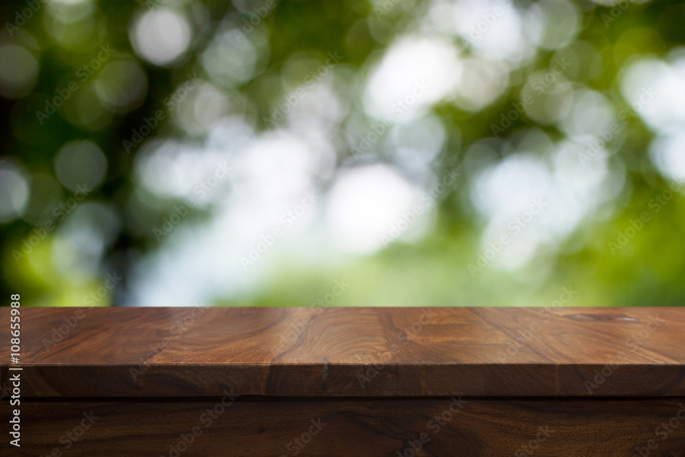 Empty top wooden table and floral blurred background Empty top wooden table and floral blurred background