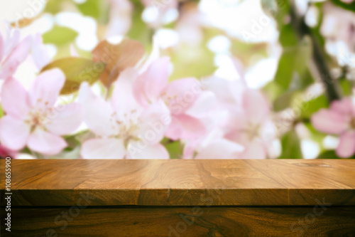 Empty top wooden table and floral blurred background