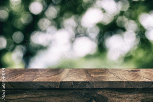 Empty top wooden table and floral blurred background