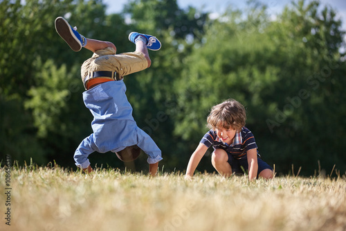 Two kids making a somersault