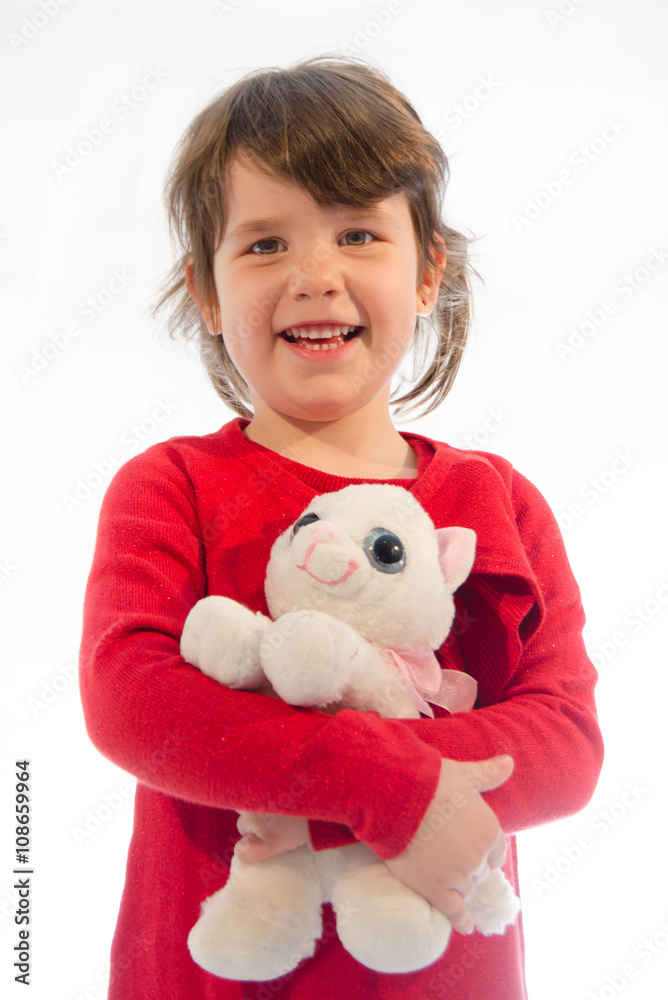 Sweet toddler girl play with pussy cat plush isolated on white Sweet toddler girl play with pussy cat plush isolated on white