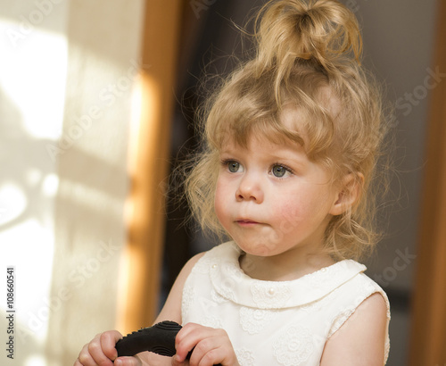 Little girl of 2 year old looking up.