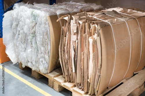 Pallets with wastepaper and wasteplastic packs photo