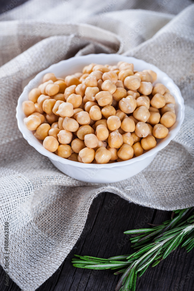 Chickpeas in bowl with rosemary, top view