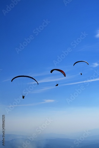 Three paragliders in a row 