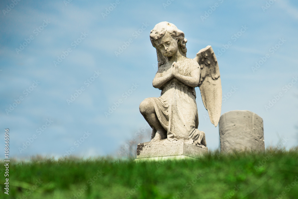 Praying Angel statue in graveyard Praying Angel statue in graveyard