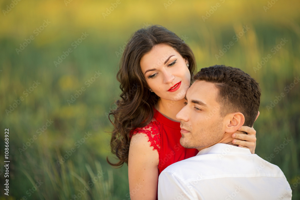 Happy young couple embrace in park Happy young couple embrace in park