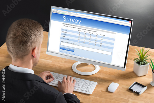 Businessman Filling Online Survey Form On Computer