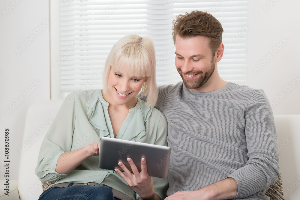 Young Couple Holding Digital Tablet