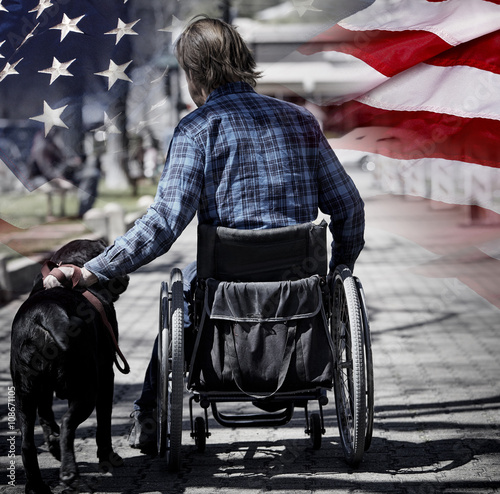 Man on wheelchair with dog concept USA veteran patriotism photo