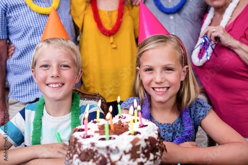 Siblings celebrating birthday party with family
