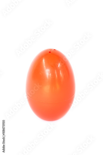 Red plastic egg on white background