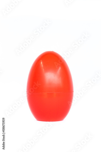 Red plastic egg on white background