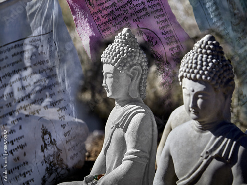 Картината върху платно Buddhist figures made of cement sitting in meditation with prayer offerings and