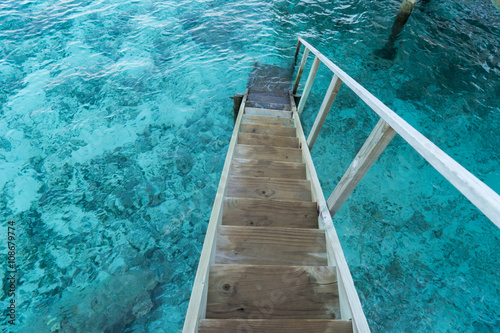 wood stair into the sea