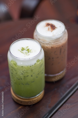 Green tea and iced chocolate on wood table.