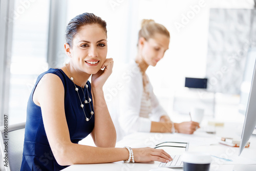 Attractive office worker sitting at desk