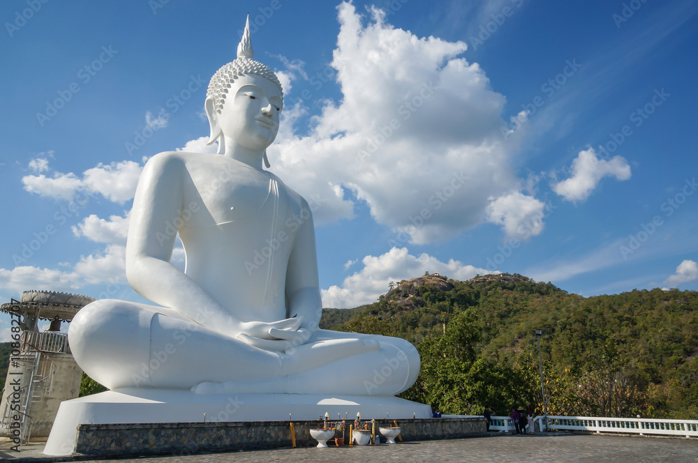The white big Buddha statue on blue sky background in Tak province, Thailand. The white big Buddha statue on blue sky background in Tak province, Thailand.