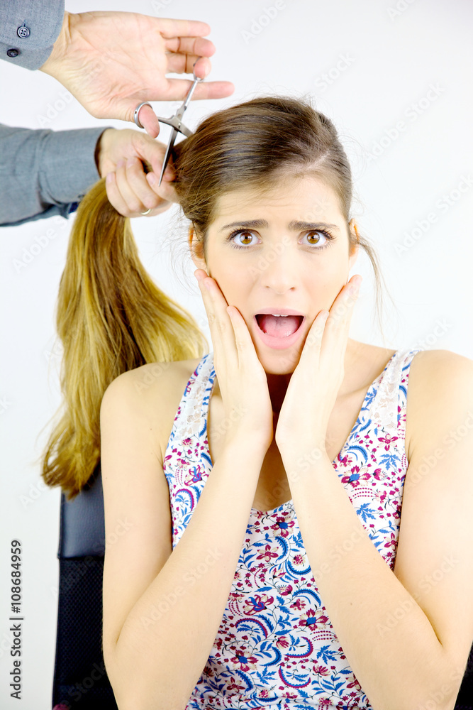 Fototapeta premium Woman scared about getting all her big long hair cut off by hairdresser