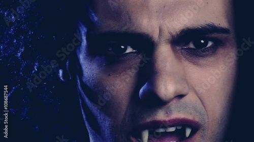 Portrait of angry vampire looking camera at night photo