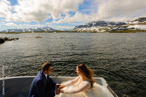 bride and groom sitting in a boat