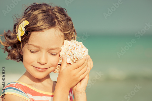 Child relaxing on the beach photo