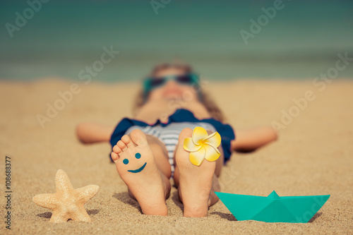 Child relaxing on the beach