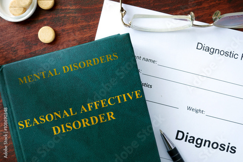 Seasonal affective disorder  concept. Diagnostic form and book on a table. photo