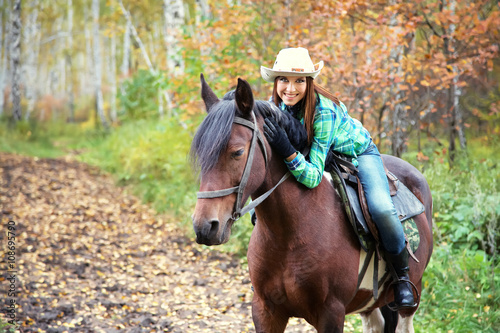 woman riding a horse © bakharev