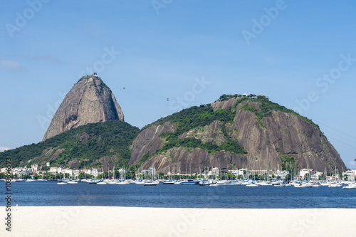 Classic daytime scenic profile view of Pao de Acucar Sugarloaf Mountain in Rio de Janeiro, Brazil standing above Botafogo Bay