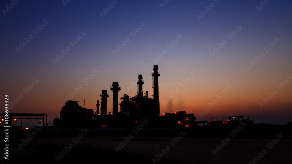 Gas turbine electrical power plant at dusk with light