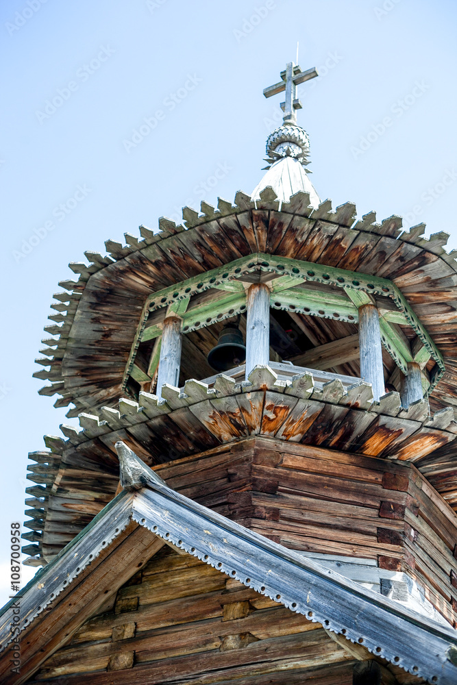 beautiful wooden church with bell tower at summer day