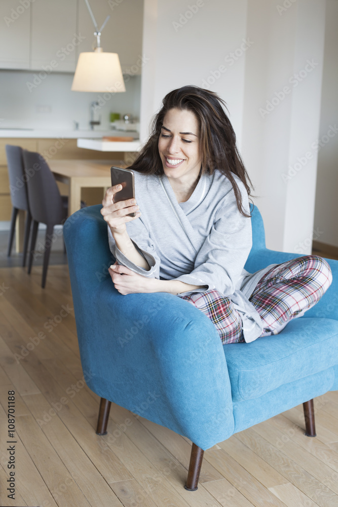 Woman sitting in sofa in the living room. Morning scene,woman smiling and talking on the phone