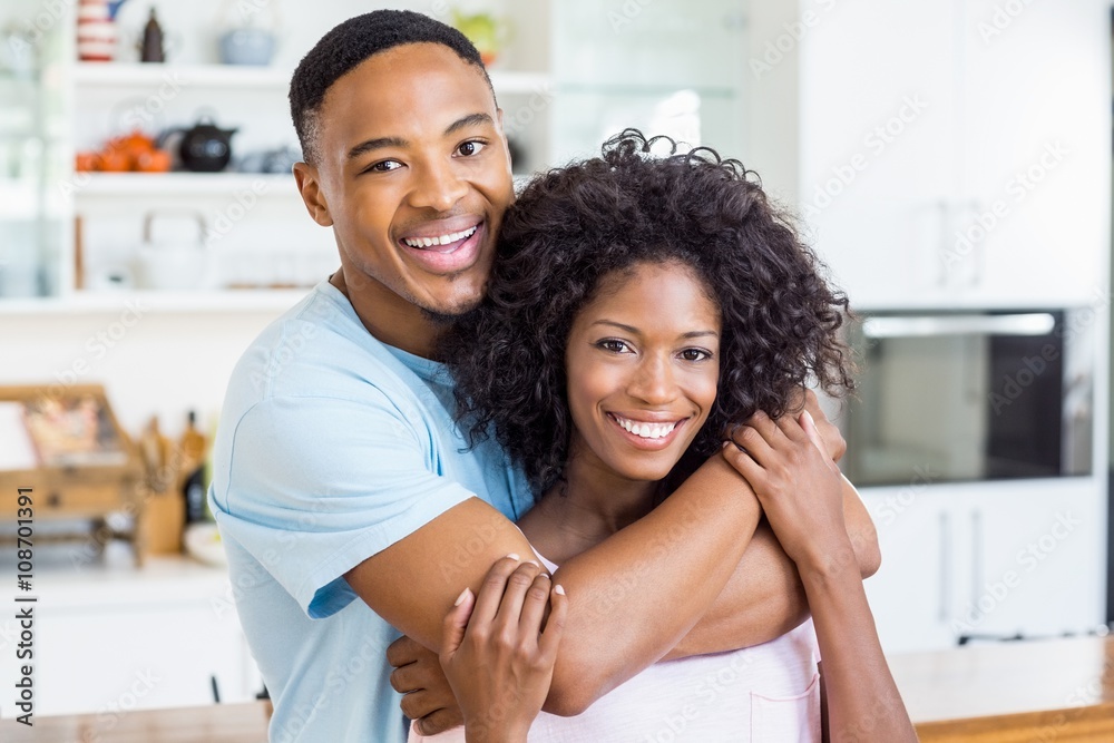 Young couple embracing in kitchen Young couple embracing in kitchen
