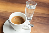 Cup of espresso coffee and glass of water