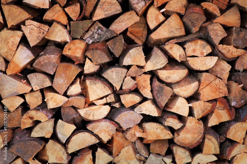 Background of chopped firewood stacked up on top of each other Background of chopped firewood stacked up on top of each other