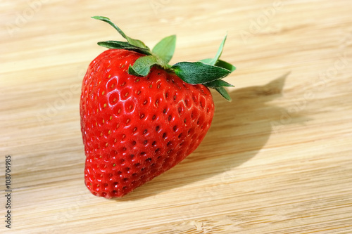 strawberry on wooden background with shadow
