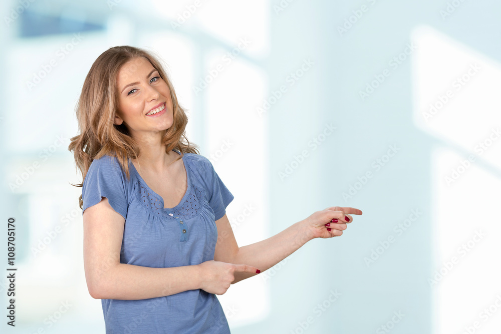 Young elegant woman pointing at white background