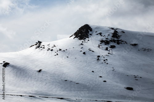 peak of mountain on winter and ski trace photo