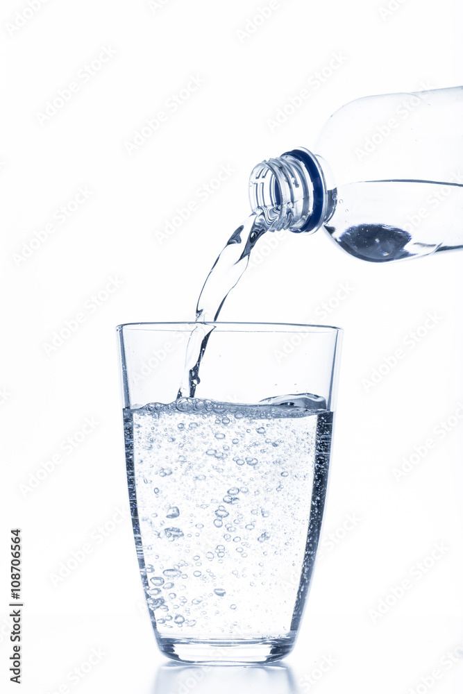 water pouring in glass isolated on white background
