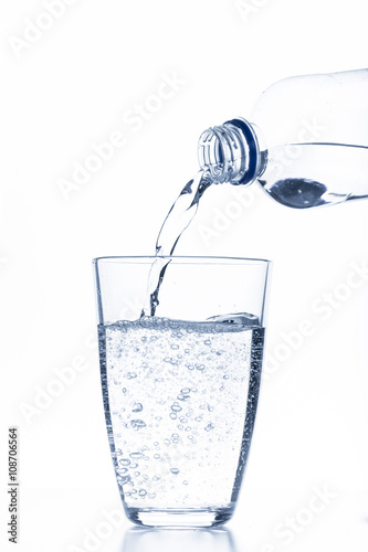 water pouring in glass isolated on white background