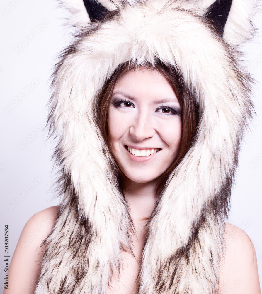 Beautiful girl dog hat, smiling happy, joke winter naked woman with gentle make-up on gray background