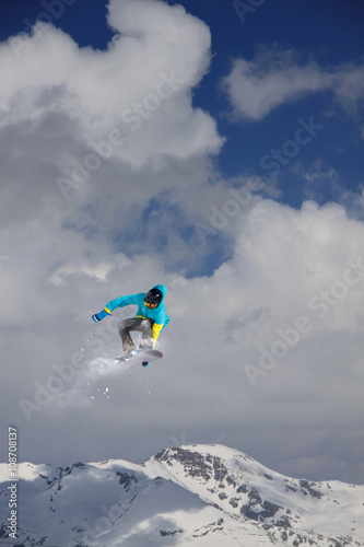 Snowboard rider jumping on mountains. Extreme snowboard freeride sport.