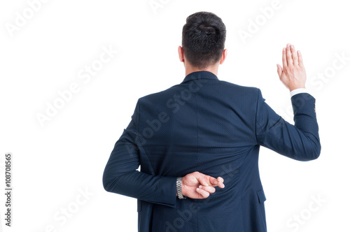 Dishonest lawyer making fake oath or pledge with fingers crossed photo