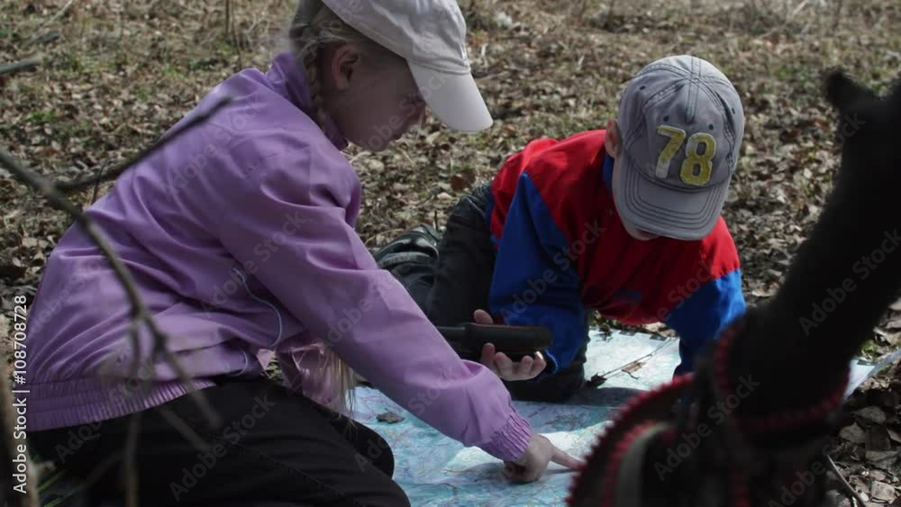 Children Sitting Look at the Map of the Campaign. Near Children Sitting Look at the Map of the Campaign. Near