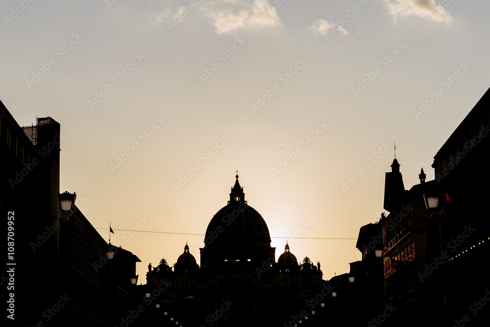 Silhouette of St. Peter's Basilica at sunset in Rome, Italy
