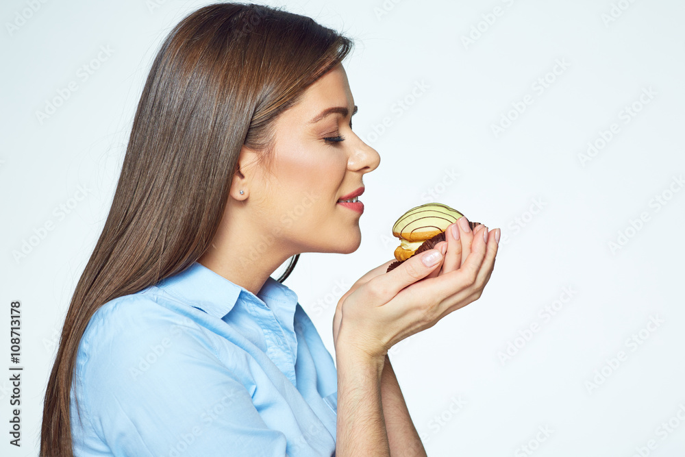 Young woman enjoying smell of cookies with closed eyes