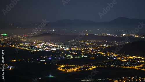 Time lapse of night life in city surrounded by mountains photo