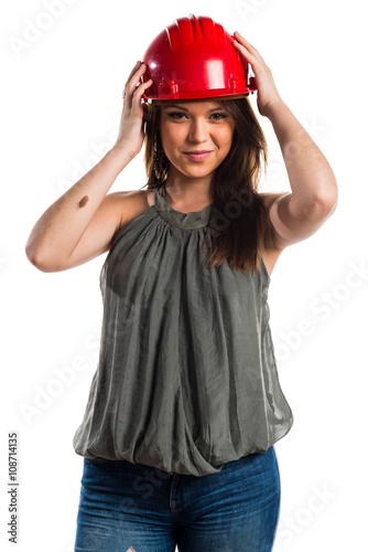 Young worker woman with red hat © luismolinero
